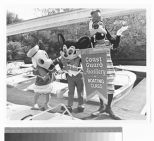 Disney mascots Mickey Mouse, Donald Duck, and Goofy promoting the U.S. Coast Guard Auxiliary boating class